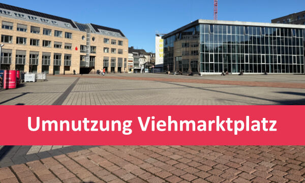 Ein Bild des Viehmarktes in Trier. Über das Bild geht ein roter Banner mit der Aufschrift "Umnutzung Viehmarktplatz"